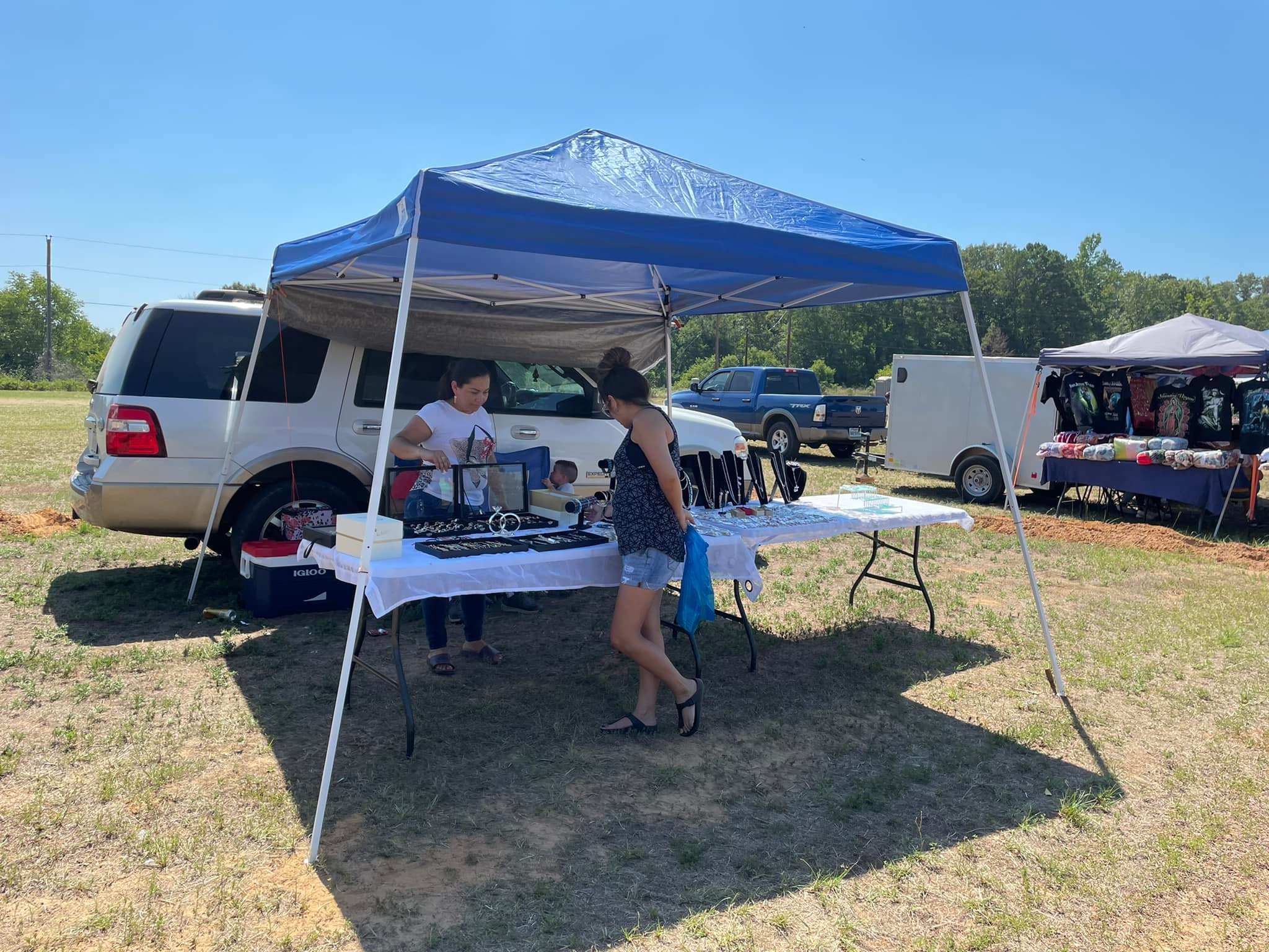 Vendors and shoppers at Henderson Trade Days outdoor flea market in Henderson TX